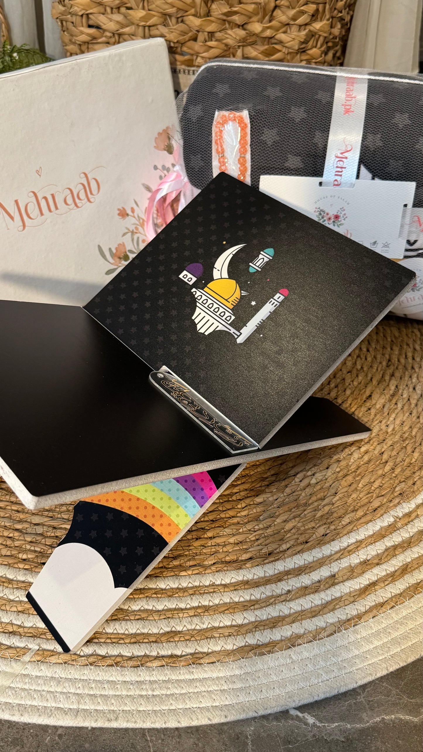 Rk07:Black Rehal with illustration of rainbow and clouds.