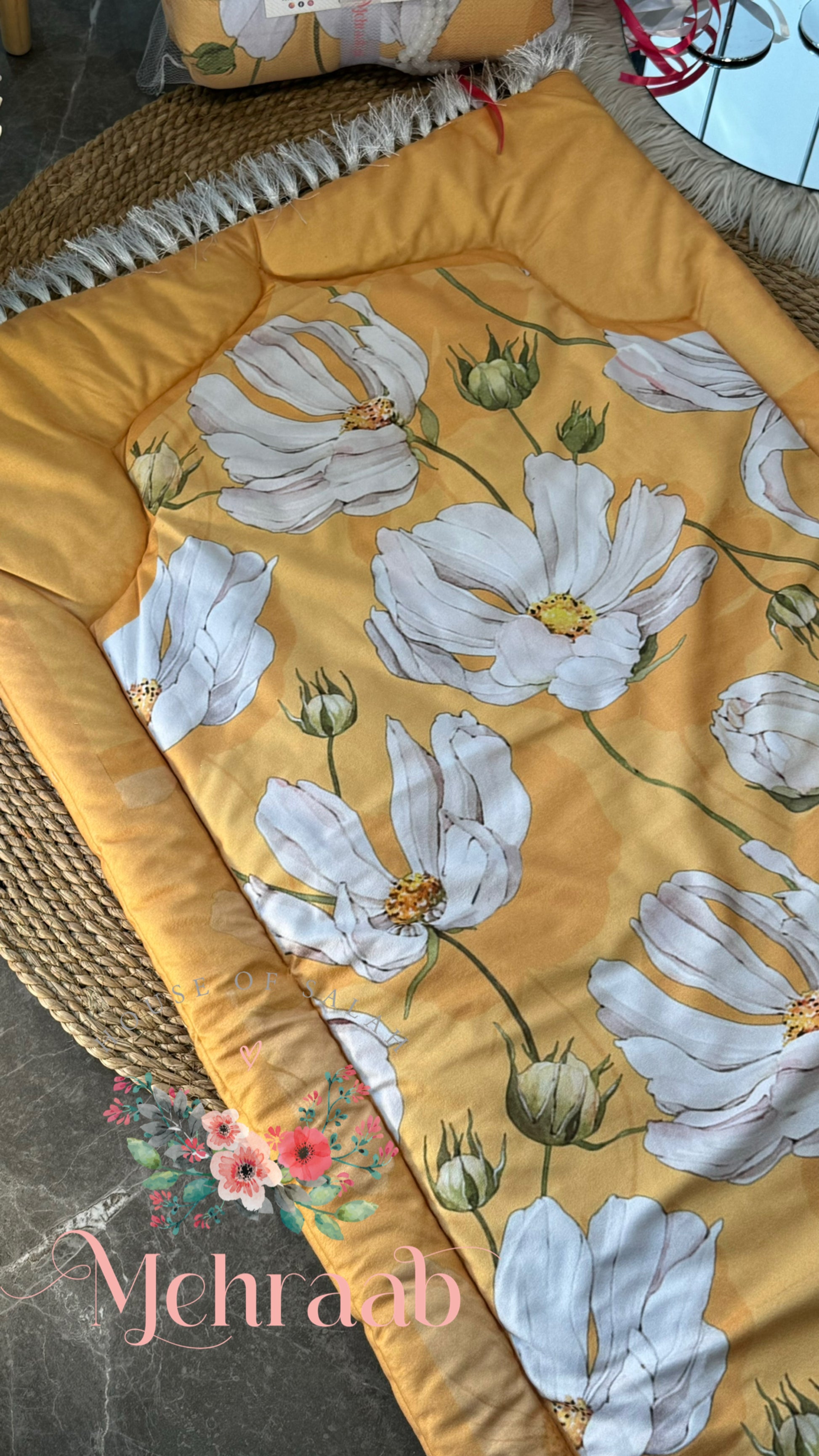 Close up of yellow janamaz with floral pattern