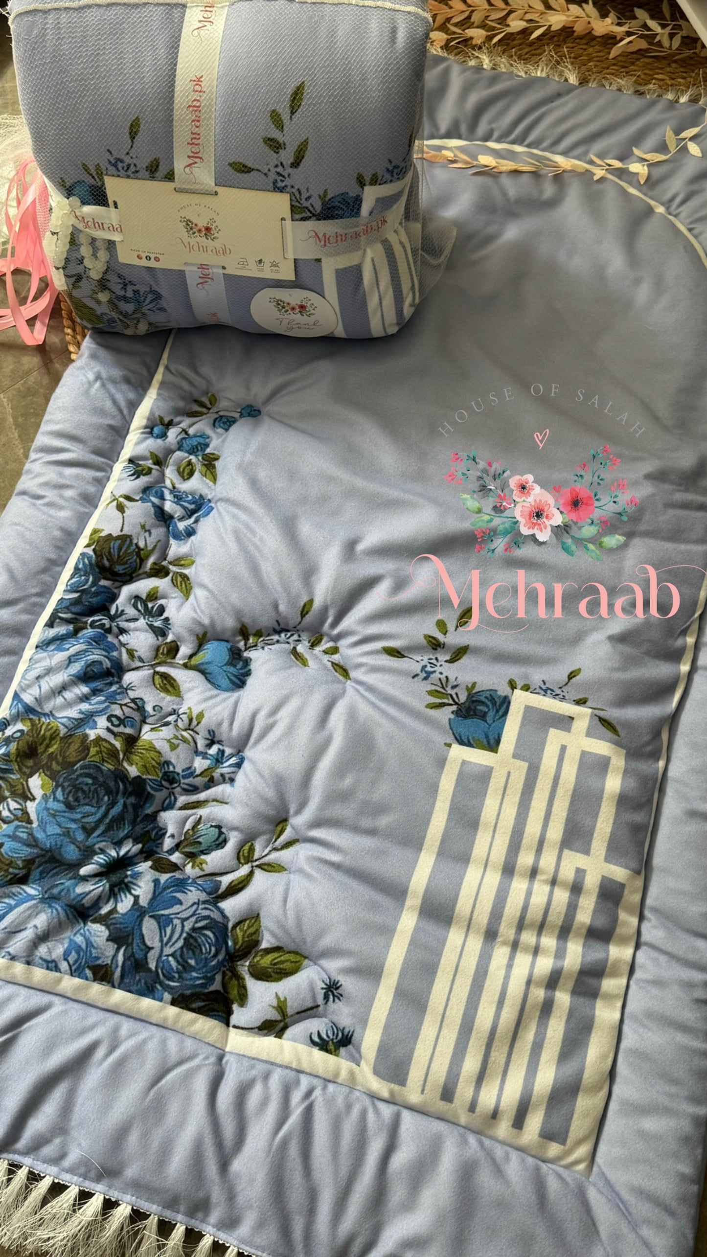 Top and packaging view of sky blue janamaz with flowers pattern