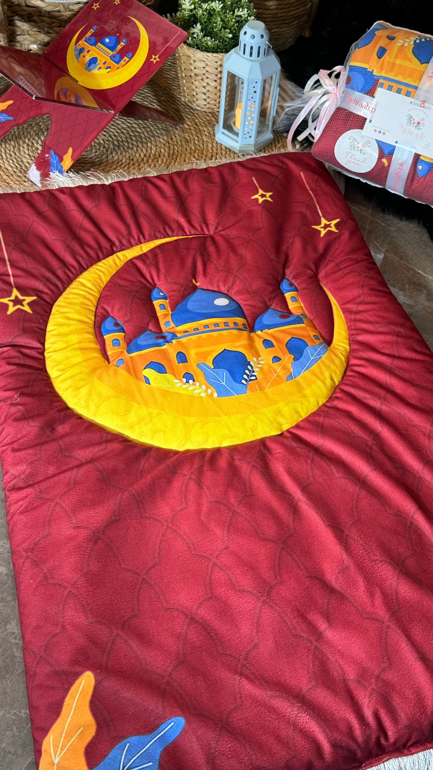 K23:Red prayer mat with vibrant yellow crescent moon.