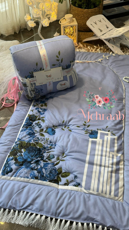 Full view of sky blue floral janamaz and its packaging